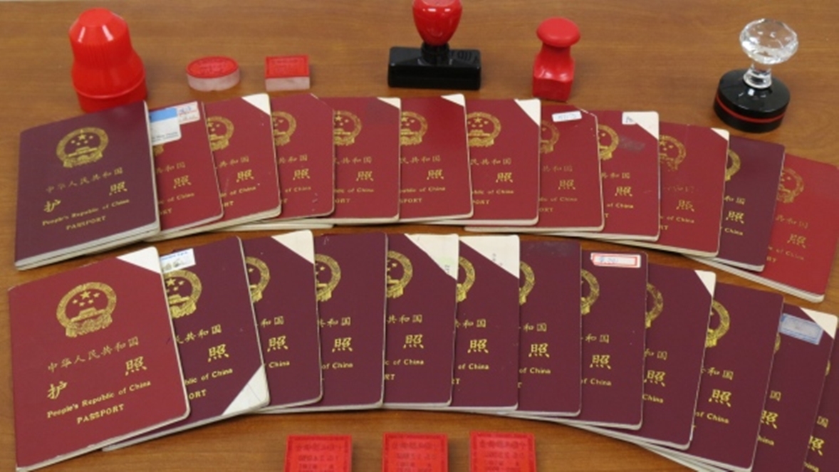 Canada Border Services Agency released this picture of passports seized from Xun Wang, as part of an investigation into his immigration fraud scheme. (CBSA)